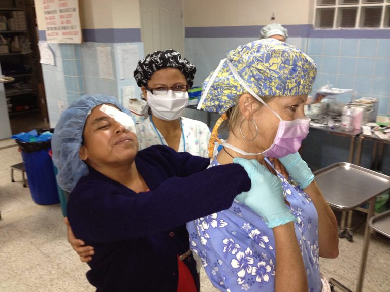 A photo of a woman patient after a cataract surgery guided by medical volunteers.