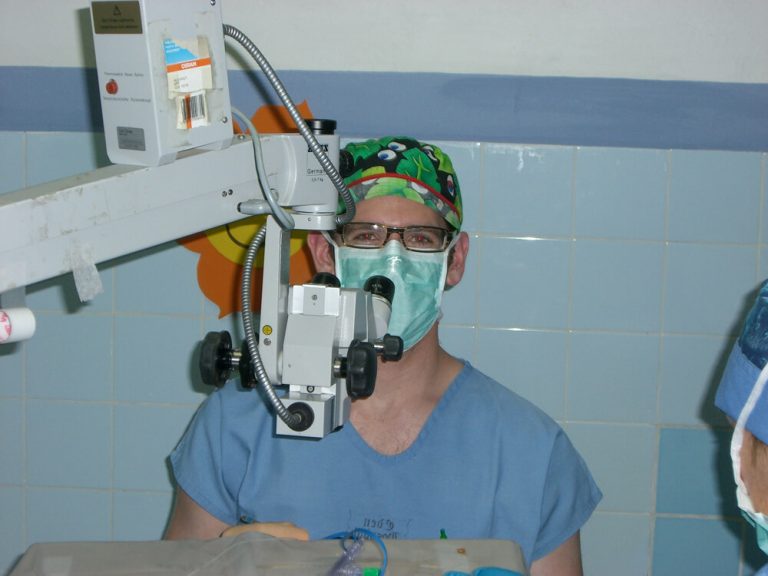 A photo of Dr. Landmann using a eye device in Guatemala on a Volunteer Cataract Surgery.