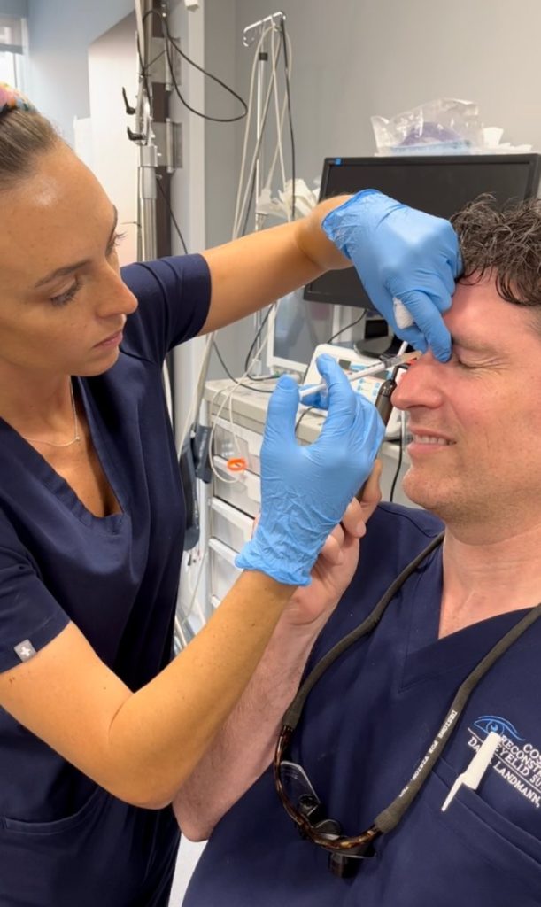A photo of Nicole Van Nes injecting Botox to Dr. Dan Landmann.